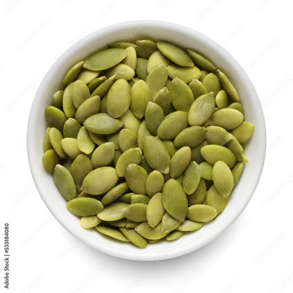 Dried pumpkin seeds in white bowl isolated on white. Top view. Dried pumpkin seeds in white bowl isolated on white. Top view.