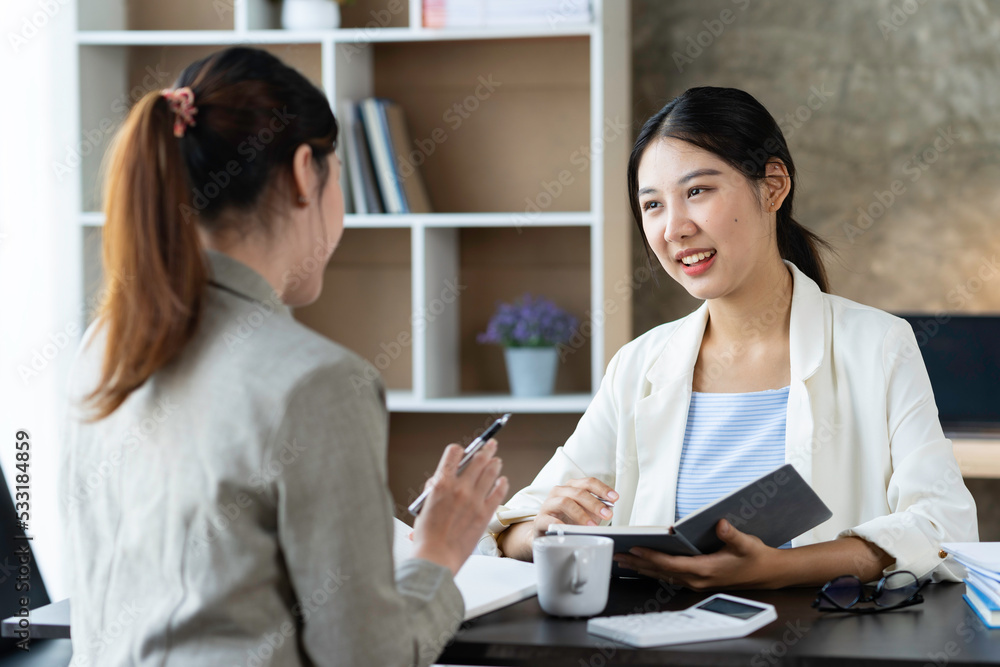Confident businesswoman discussing the project with colleague close up, diverse employees working together, executive consulting Asian woman client, mentor teaching trainee in the Confident businesswoman discussing the project with colleague close up, diverse employees working together, executive consulting Asian woman client, mentor teaching trainee in the
