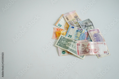 Banknotes from different currencies on white background