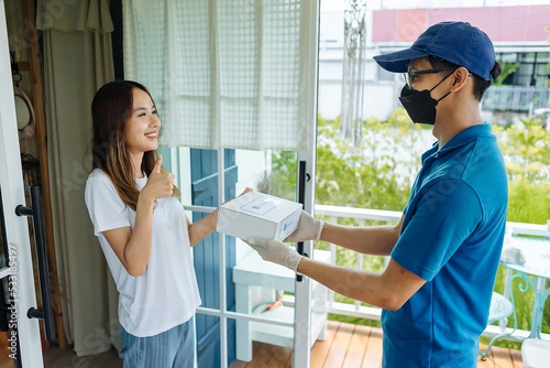 Medicine delivery man courier in mask and gloves with medical pills purchases during the prevention of coronovirus, Safety home and quarantine concept, Volunteer with Donation goods.