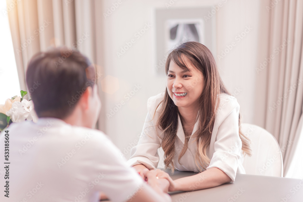 marriage couple holding hands looking in the eyes. happy handsome husband and beautiful wife enjoy watching each other eyes while touch hands together. boyfriend and girlfriend living in good house marriage couple holding hands looking in the eyes. happy handsome husband and beautiful wife enjoy watching each other eyes while touch hands together. boyfriend and girlfriend living in good house