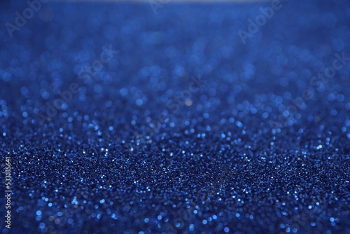 Shiny blue glitter as background. Bokeh effect