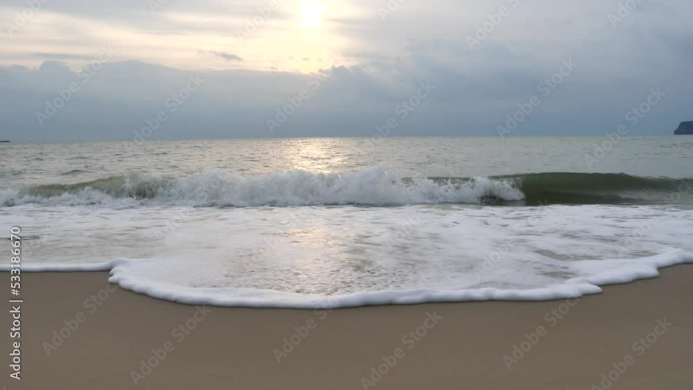The sea waves are lapping against the shore as white foam spreads at the beautiful beach in the early morning sun. white wave bubble.
The sea waves are lapping against the shore as white foam spreads at the beautiful beach in the early morning sun. white wave bubble.