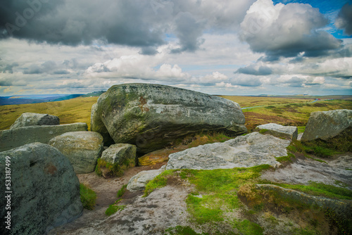 Hill walking on the gritstone outcrops on Higger Tor in the De rbyshire Peak Distrct photo