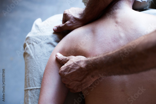 Male massage therapist working with a female client. 