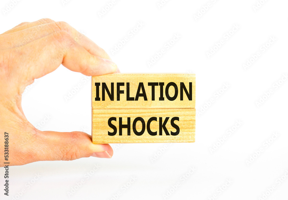 Inflation shocks symbol. Concept words Inflation shocks on wooden blocks. Beautiful white table white background. Businessman hand. Business inflation shocks concept. Copy space. Inflation shocks symbol. Concept words Inflation shocks on wooden blocks. Beautiful white table white background. Businessman hand. Business inflation shocks concept. Copy space.
