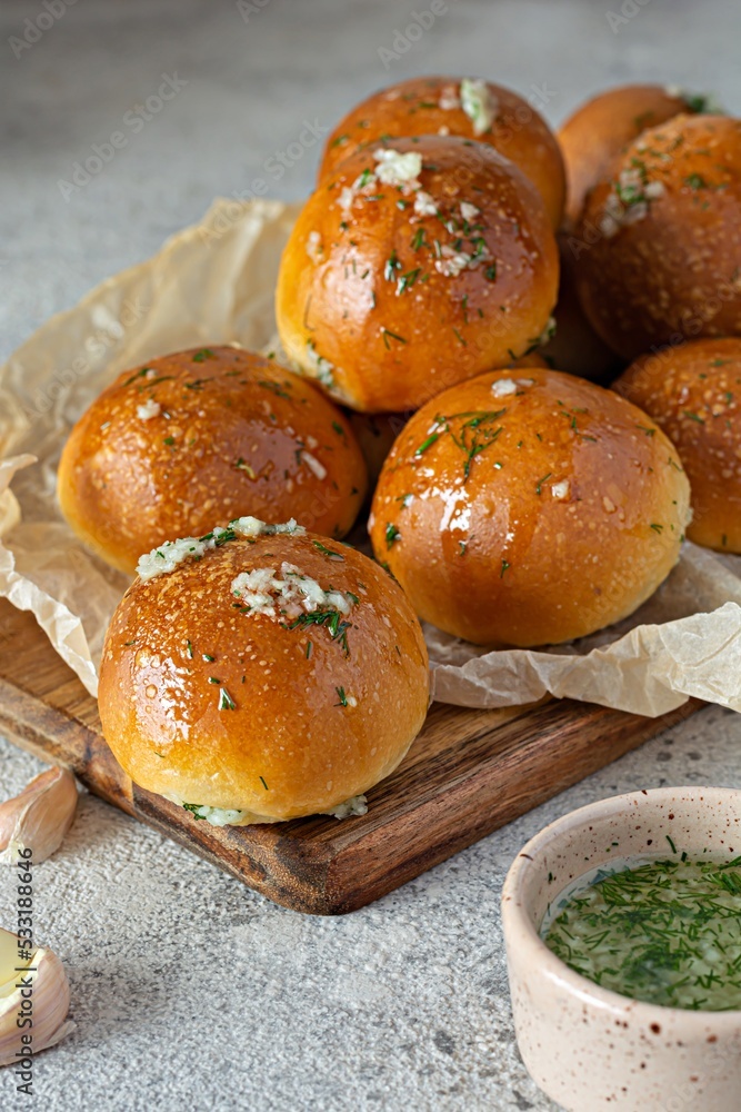 Freshly baked buns (pampushki) with garlic and dill for the first course (soup) on a baking tray. National Ukrainian dish, food. Selective focus. Freshly baked buns (pampushki) with garlic and dill for the first course (soup) on a baking tray. National Ukrainian dish, food. Selective focus.