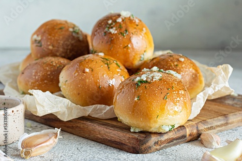 Freshly baked buns (pampushki) with garlic and dill for the first course (soup) on a baking tray. National Ukrainian dish, food. Selective focus. photo