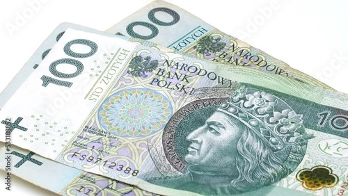Recalculation of money. Hands count Polish Zloty bills on white background. Official currency of the National Bank of Poland Zloty Zl PLN. One and two hundred zloty banknotes pack. Banknotes in hands