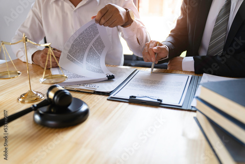 Attorneys or lawyers who are reading the statute of limitations Consultation between male lawyers and business clients, tax and legal and legal services firms.... photo