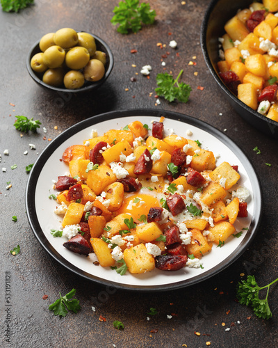 Quadro su tela Chorizo potato hash breakfast with eggs and feta cheese