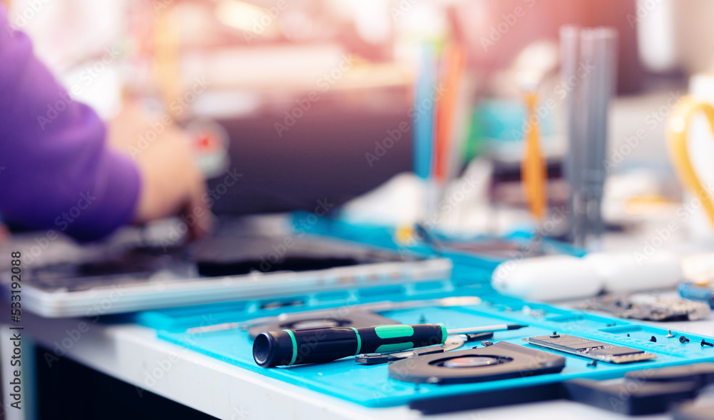 Worker technician repairing broken laptop notebook with screwdriver, keyboard replacement for modern computer Worker technician repairing broken laptop notebook with screwdriver, keyboard replacement for modern computer