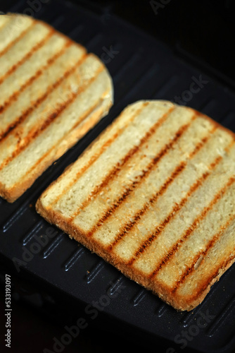 Grilled fried toasts on the grill.