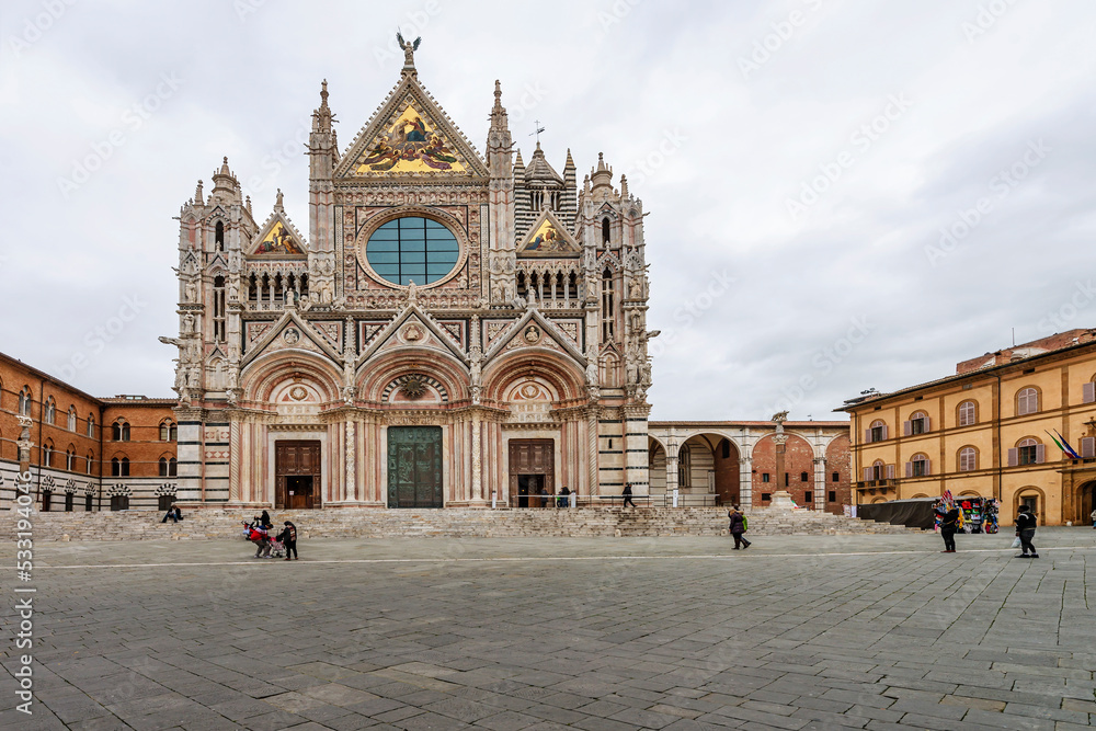 Facade of the Siena Cathedral. It's a medieval church dedicated from its earliest days as Roman Catholic Marian church. The cathedral was completed in 1263. Italy, 2019