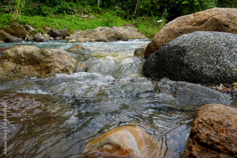 river with rocks in tropical indonesian nature river with rocks in tropical indonesian nature