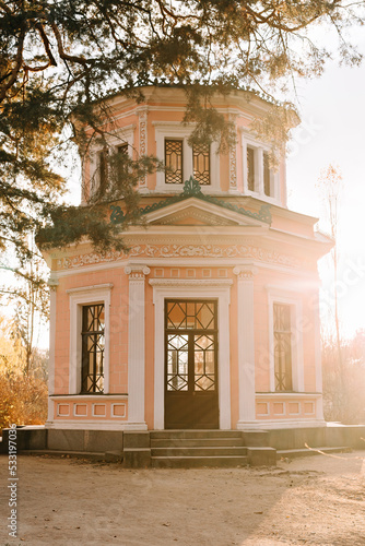 Pink pavilion in autumn park. Sunny weather. Fall season.