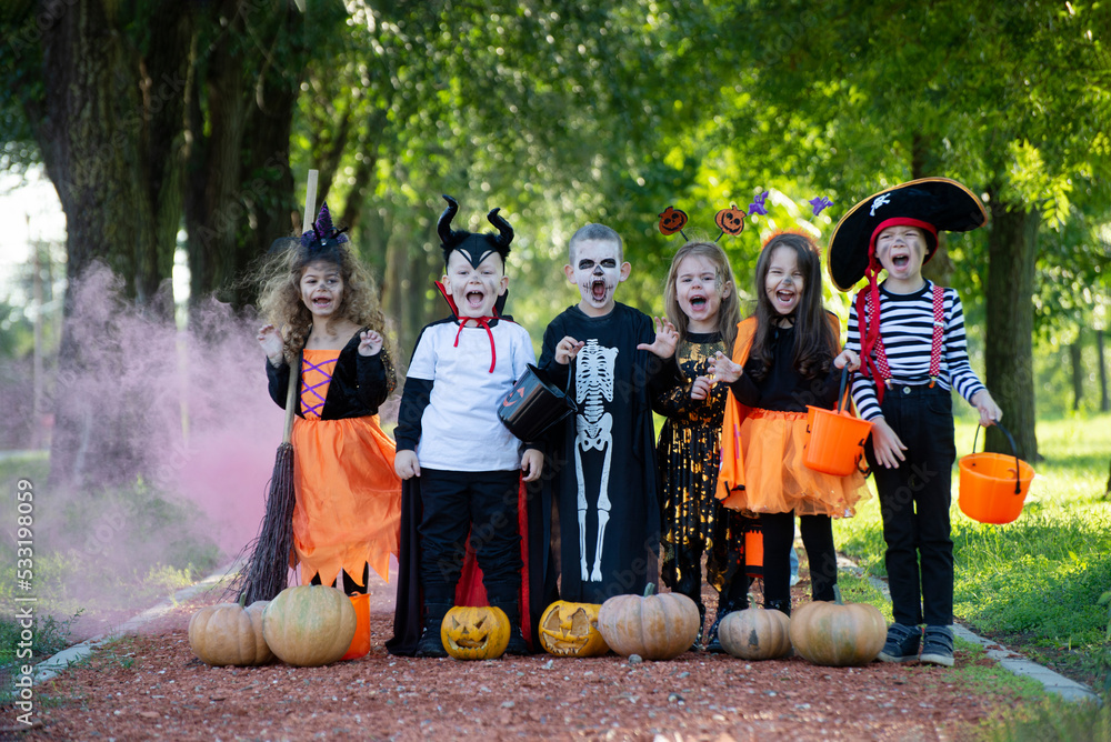 Fototapeta premium Today's day is full of fun. Happy group of kids on Halloween