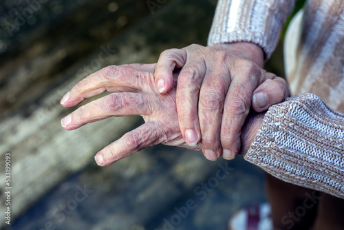 close-up of old woman rubbing her hands