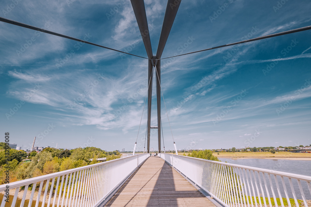Suspension footpath bridge over the Rhine River in Dusseldorf, Germany