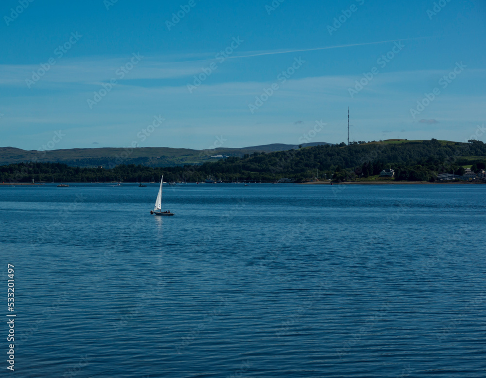 Obraz premium Landscape of Gare Loch with single sail boat