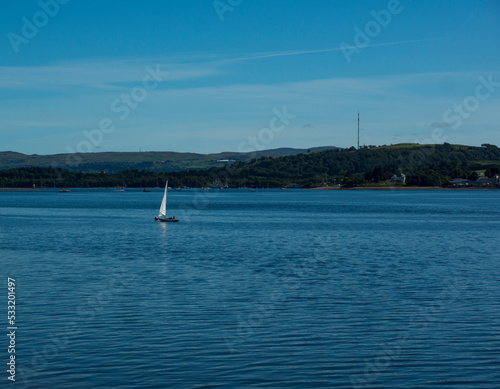 Landscape of Gare Loch with single sail boat