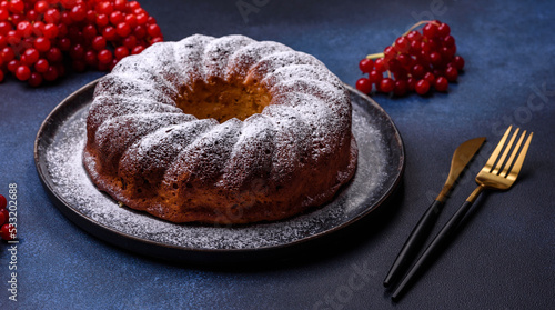 Homemade delicious round Christmas pie with red berries on a ceramic plate