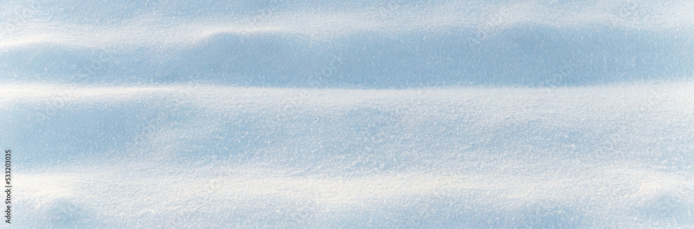 Winter background with snow-covered wavy uneven ground surface, snow texture Winter background with snow-covered wavy uneven ground surface, snow texture
