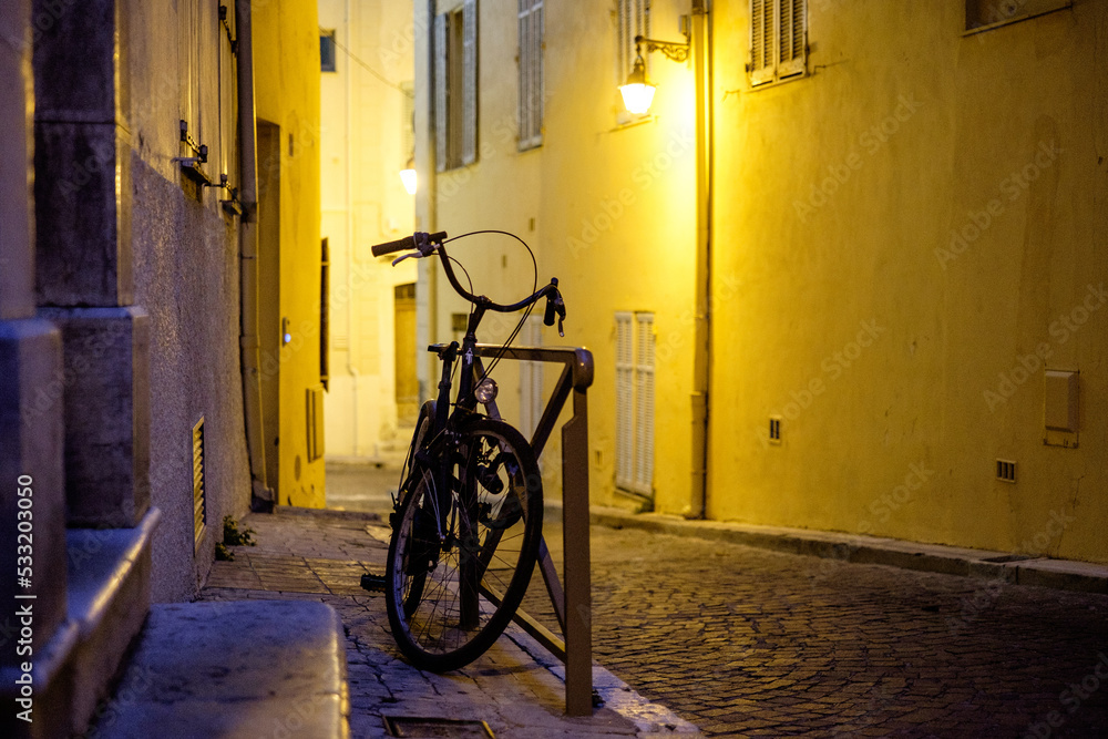 Lone bike in Antibes, France at night Lone bike in Antibes, France at night