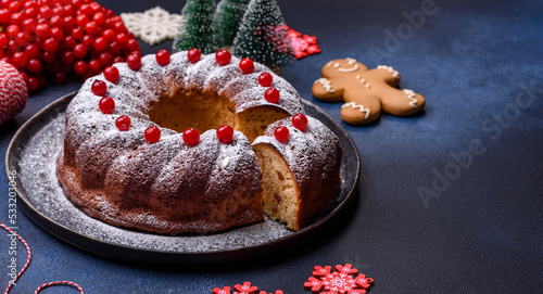 Homemade delicious round Christmas pie with red berries on a ceramic plate