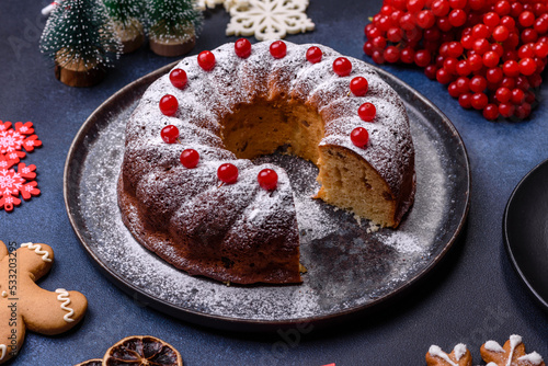 Homemade delicious round Christmas pie with red berries on a ceramic plate