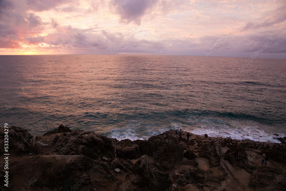 Fototapeta premium sunset over the sea waves on rocks