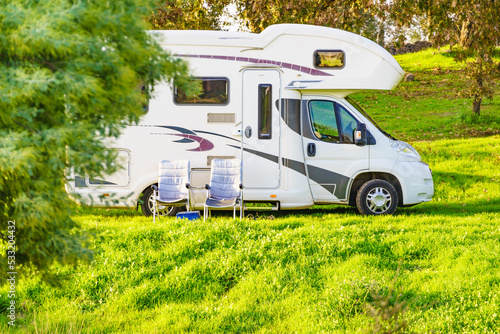 Camper and chairs on nature