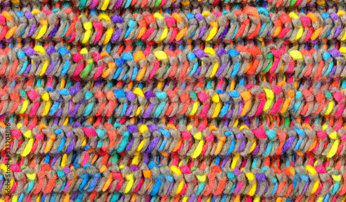 Pattern fabric wool Background. relax autumn and winter season arrangement flat lay style. Knitting wool scarf. Knitted cloth from multi-colored woolen threads. Multicolored woolen soft texture.