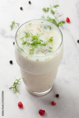 Close-Up of summer drink  Buttermilk or mattha or Chhachh glass garnished with coriander made with milk and curd. photo