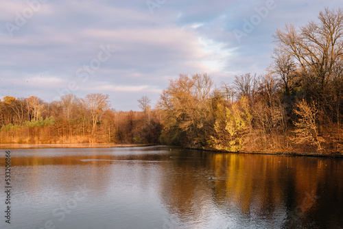 Lake in autumn park. Autumn landscape in the park. Sunny weather. Fall season.