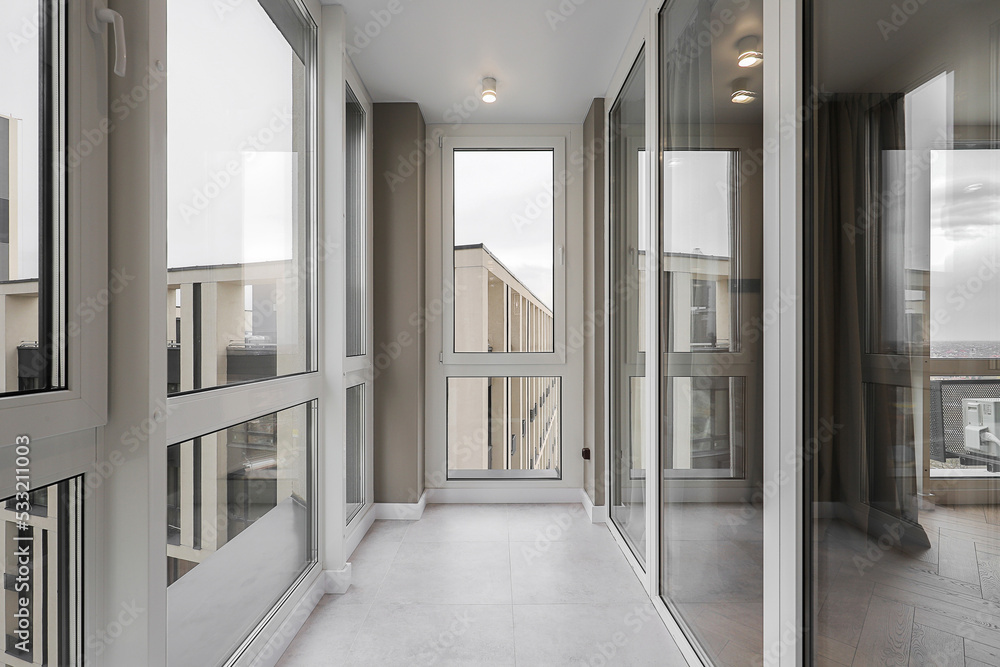 Modern loggia with large windows in the apartment - obrazy, fototapety, plakaty 