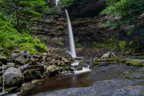 the Hardraw Force waterfall in the Yorkshire Dales in lush green summer splendour photo