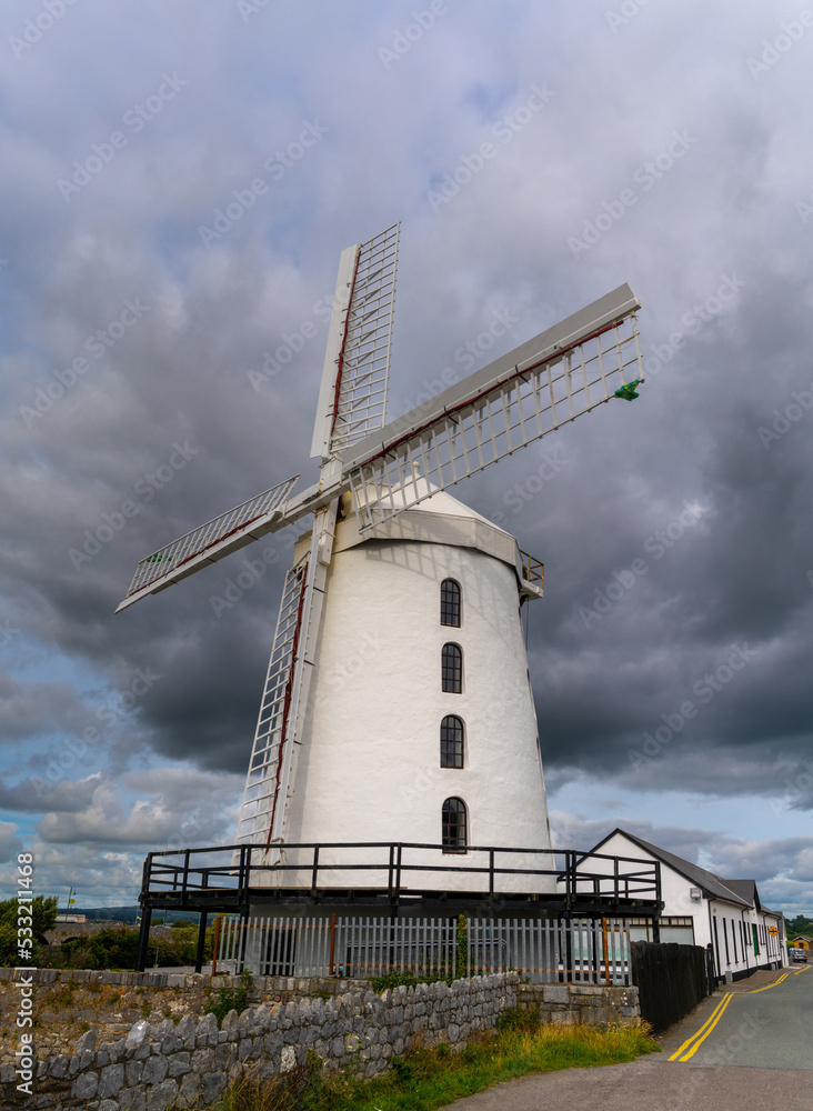 view of the historic Blennerville Windmill in Tralee Bay in western Ireland under stormy skies