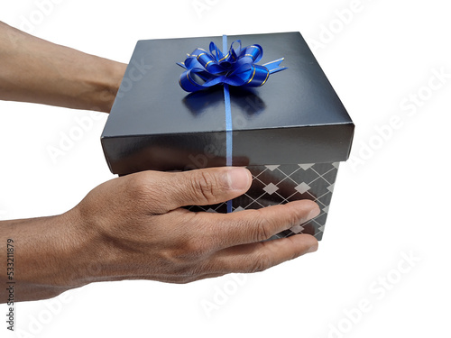 Hands offering black box gift with bow on top as holiday concept. Black friday. Giving a gift photo