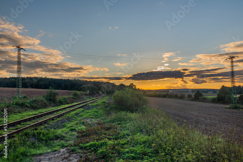 Old non electrified railway track near Rakovnik town in sunset evening