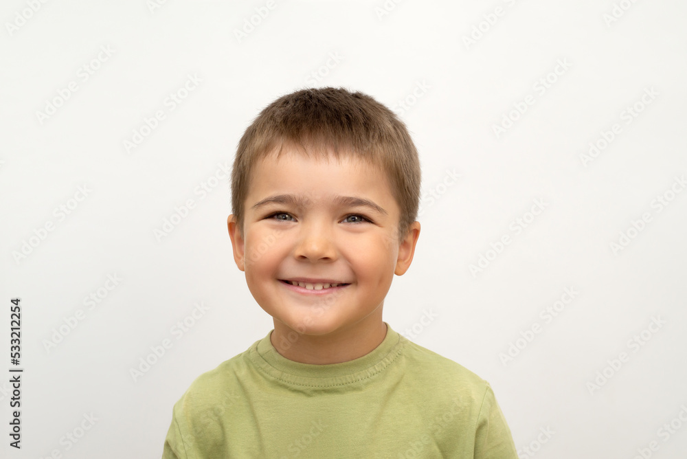 little cute boy smiling. face of a happy child close-up on a white isolated background. portrait of a 5 year old baby little cute boy smiling. face of a happy child close-up on a white isolated background. portrait of a 5 year old baby
