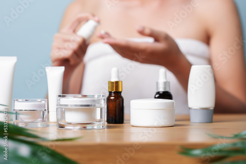 Close-up of Skincare facial cream products many various kinds on the wooden table with green leaf  Skincare and facial clean with various products  product selection  safety skincare product