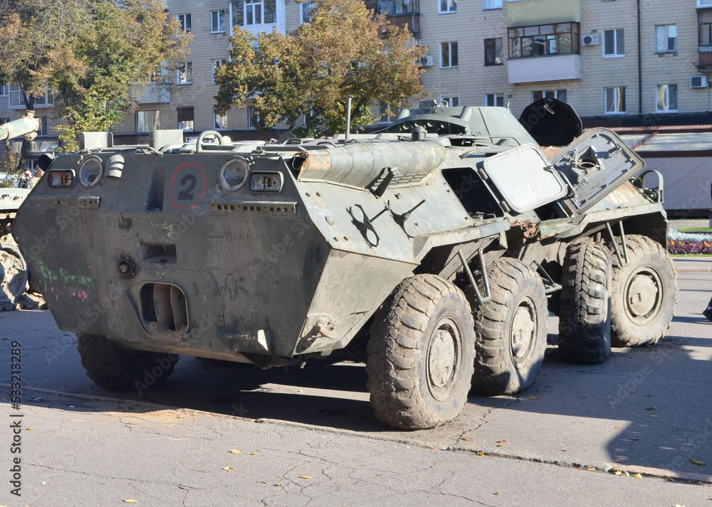 Fototapeta premium Armored personnel carrier stands on the street of the city.