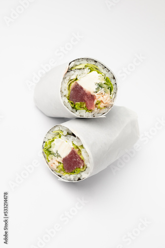 Fresh rolls with salmon, tuna, rice and cream cheese on a white background
