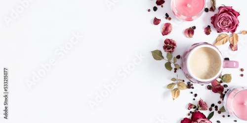 Autumn composition with cup of coffee, dry roses and candles. Autumn background in pastel colors with dried pink flowers and leaves. Flat lay, top view, copy space