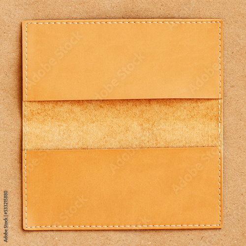 Close-up of opened leather wallet, purse on wooden surface