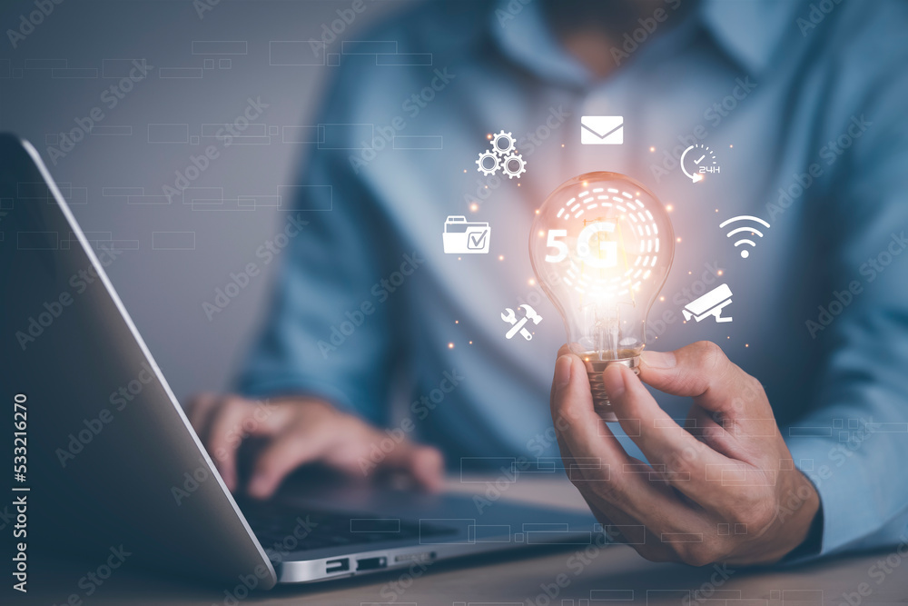 Fototapeta premium thinking and creative concept, Close up the light bulb and man working on the desk, Creativity, and innovation are keys to success, new idea and innovation with Brain and light bulbs,big data