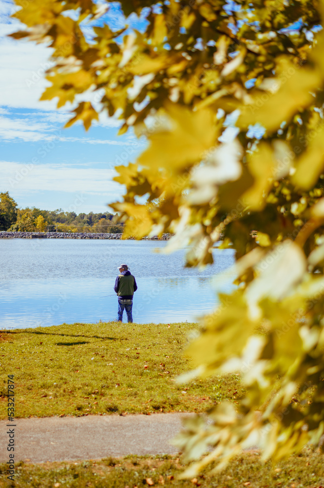 Obraz premium Person fishing on the lake.