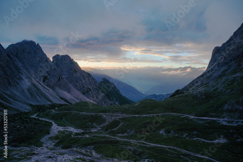 colorful sunset in mountains,Ausrtian Alps view from peack to valley. Multicolor clouds. Amazing landscape with mountain.