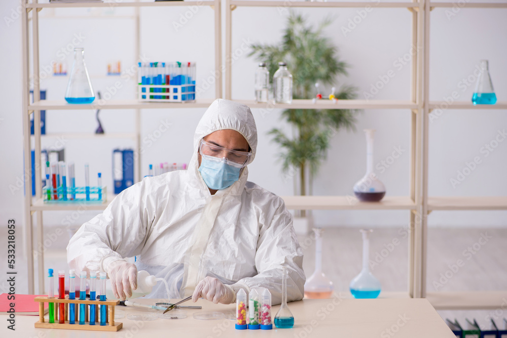 Young male chemist working at the lab during pandemic Young male chemist working at the lab during pandemic